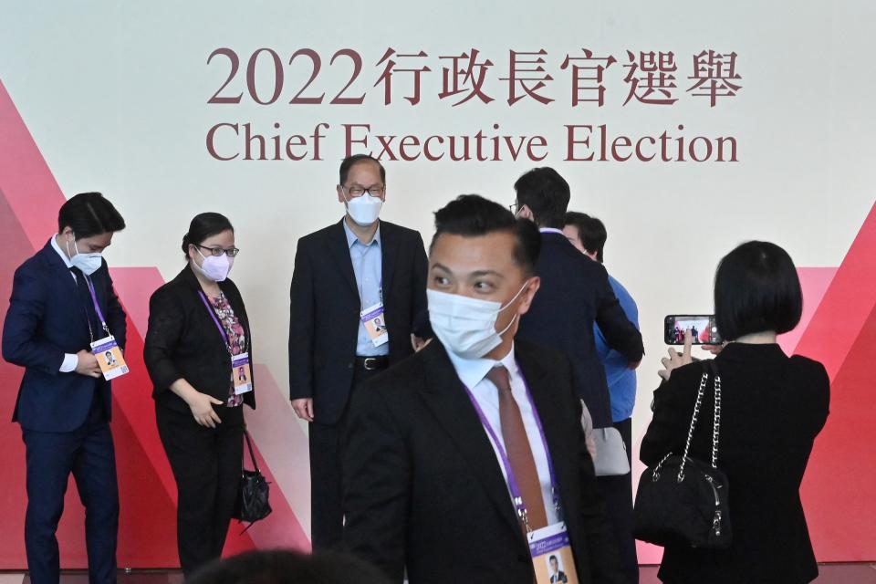 Election committee members and officials arrive for the selection process of the city's new chief executive in Hong Kong on May 8, 2022. - John Lee, 64, is expected to be anointed Hong Kong's next chief executive by a small committee on May 8, the culmination of a choreographed, Beijing-blessed race with no other candidates. (Photo by Peter PARKS / AFP) (Photo by PETER PARKS/AFP via Getty Images)