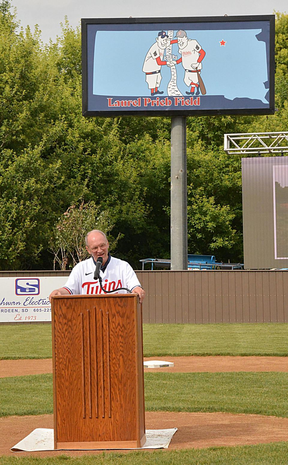 With the new stadium sign unveiled in the background, Laurel Prieb speaks during a grand opening ceremony for the Laurel Prieb Casual Play Field at the Veterans Memorial Sports Complex on Friday, June 23, 2023.