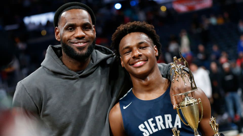 LeBron James, left, poses with his son Bronny after Sierra Canyon beat Akron St. Vincent - St. Mary in a high school basketball game on December 14, 2019, in Columbus, Ohio. - Jay LaPrete/AP
