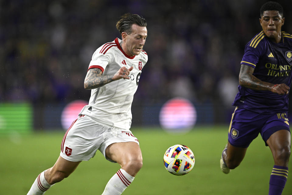 Toronto FC forward Federico Bernardeschi, left, is defended by Orlando City midfielder Wilder Cartagena during the first half of an MLS soccer match, Saturday, April 27, 2024, in Orlando, Fla. (AP Photo/Phelan M. Ebenhack)