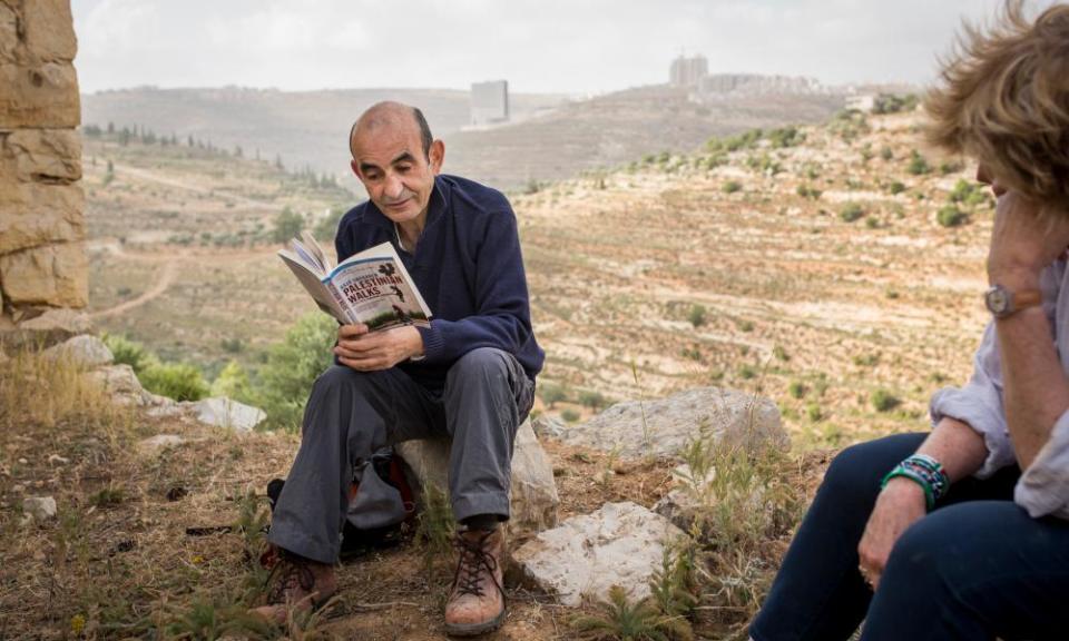 Raja Shehadeh, reading to visiting journalists from his work in the terraced hills outside Ramallah in the West Bank in 2014.