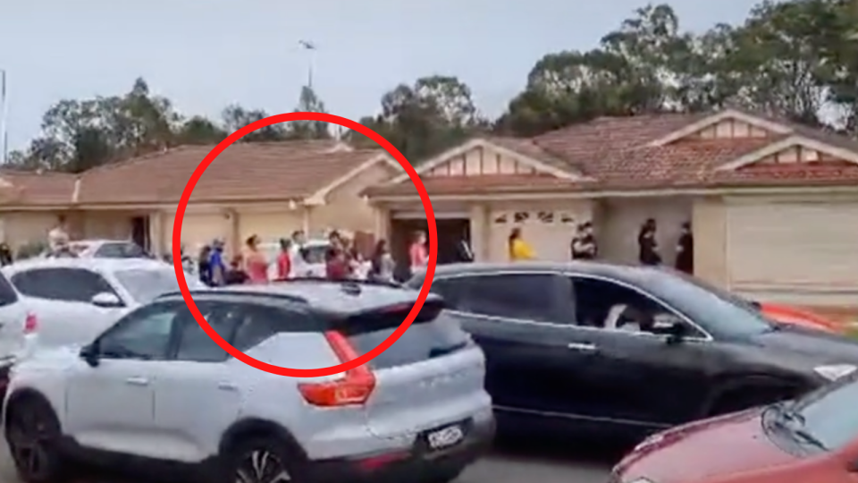 A still image from a TikTok video showing a street completely blocked as hundreds of people turn up for a house inspection.