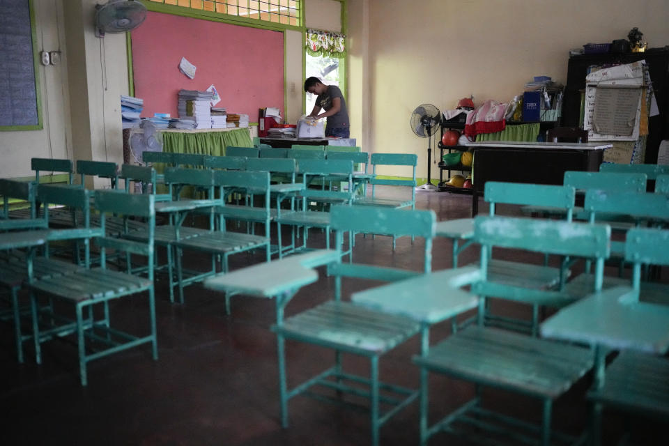 A teacher arranges papers at an empty classroom as classes shifted to online mode at the Justo Lukban Elementary School in Manila, Philippines on Monday, April 29, 2024. Millions of students in all public schools across the Philippines were ordered to stay home Monday after authorities cancelled in-person classes for two days as an emergency step due to the scorching heat and a public transport strike. (AP Photo/Aaron Favila)