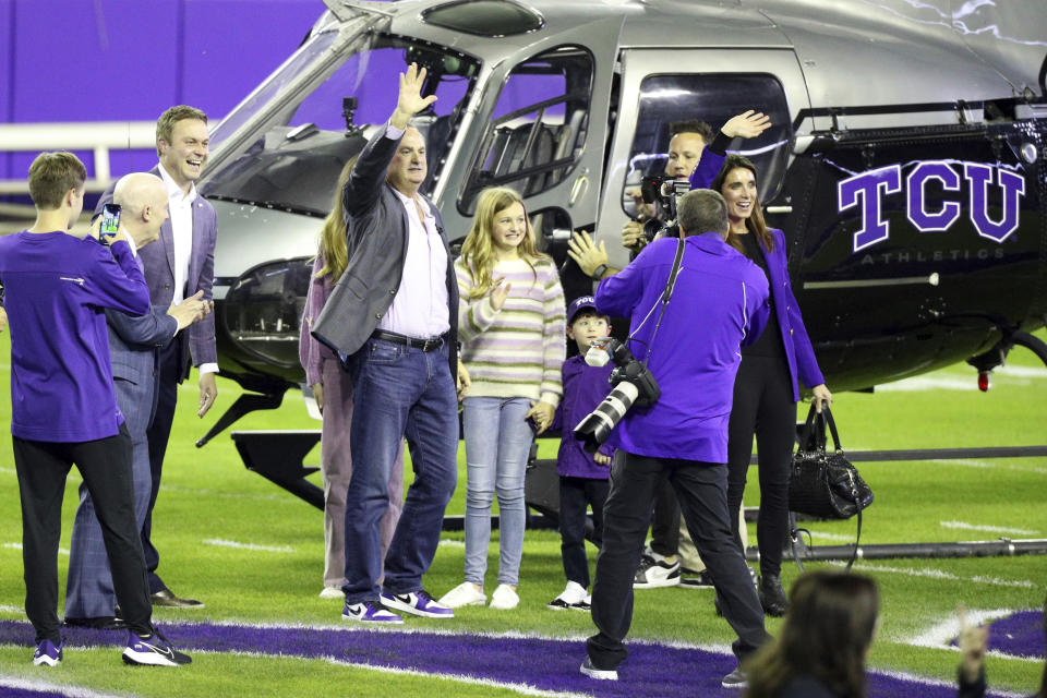 New TCU head football coach Sonny Dykes waves to the crowd after stepping out of a helicopter with his family at an event at Amon G. Carter Stadium at Texas Christian University, Monday, Nov. 29, 2021, in Fort Worth, Texas. (AP Photo/Richard W. Rodriguez)