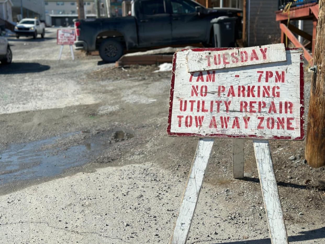 A sign on 49A Avenue in Yellowknife notifying residents of a utility repair. The area has been experiencing regular water main breaks in the past few months. Yellowknife's director of public works, Chris Greencorn, said the city will be working in the neighbourhood this summer to prevent further problems.  (Graham Shiskov/CBC - image credit)