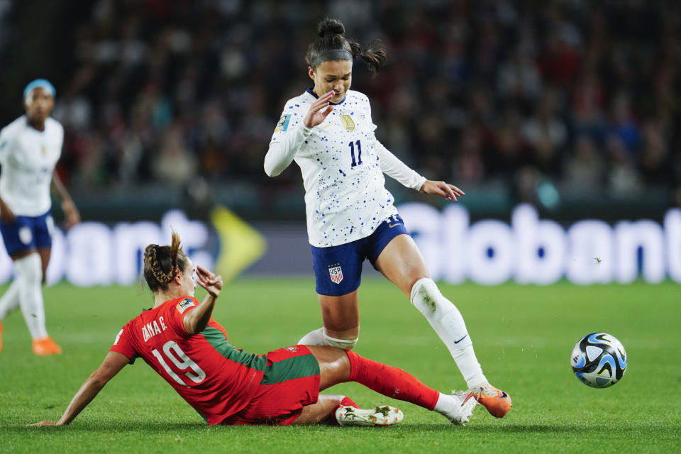 Portugal's Diana Gomes, left, tackles United States' Sophia Smith during the Women's World Cup Group E soccer match between Portugal and the United States at Eden Park in Auckland, New Zealand, Tuesday, Aug. 1, 2023. (AP Photo/Abbie Parr)