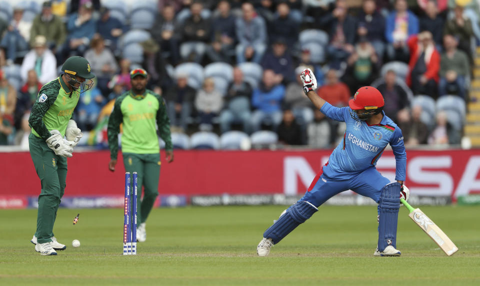 The bales fall as Afghanistan's Noor Ali Zadran is bowled by South Africa's Imran Tahir during the ICC Cricket World Cup group stage match at The Cardiff Wales Stadium in Cardiff, Wales, Saturday June 15, 2019. (David Davies/PA via AP)