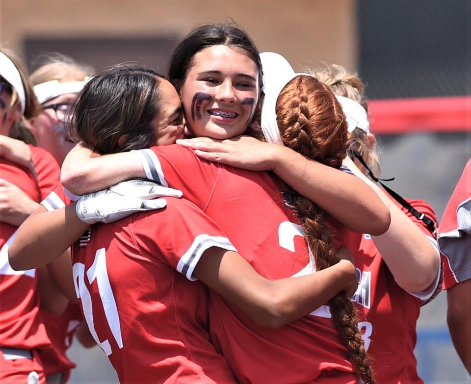 Hermleigh's Hailey Minton, center, celebrates with Juli Munoz, left, and Sarah Murphy after the Lady Cardinals beat Eula.