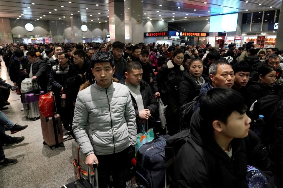 Travellers wait for their train at a railway station as the annual Spring Festival travel rush begins ahead of the Chinese Lunar New Year, in Beijing, China January 10, 2020.