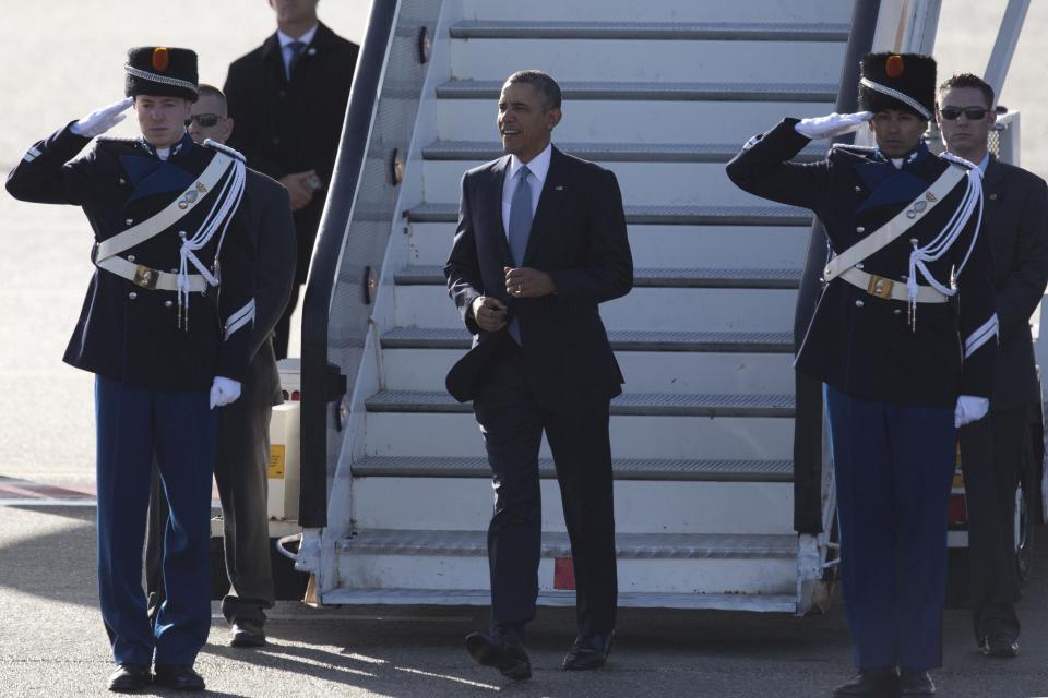 President Barack Obama walks down the stairs from Air Force One upon arrival at Schiphol Amsterdam Airport, Netherlands, Monday March 24, 2014. Obama will attend the two-day Nuclear Security Summit in The Hague. (AP Photo/Peter Dejong, POOL)