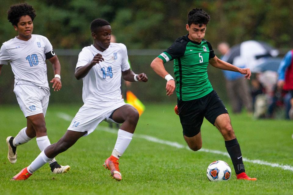 Bremen's Alex Alvarado tries to get away from Saint Joseph's Nick Njuguna during the Bremen vs. Saint Joseph sectional semifinal soccer match Wednesday, Oct. 6, 2021 at the Northfield Athletic Complex in South Bend. 