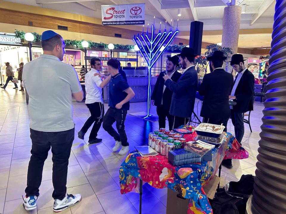 Members of the public stopped the enjoy the festival honoring the sixth day of Hanukkah held at Westgate Mall Tuesday night.