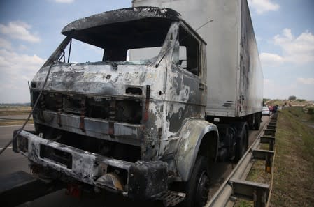 A burned truck is seen after an armed gang robbed a securities company at the Viracopos airport freight terminal, in Campinas