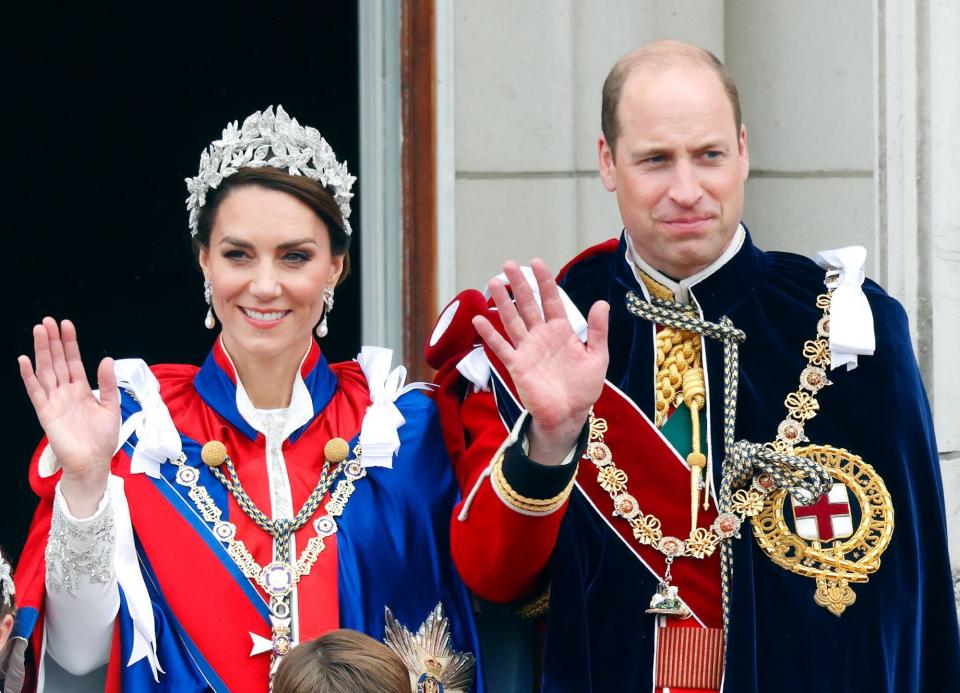 Kate Middleton and Prince William wave from a balcony during King Charles' coronation in May 2023.