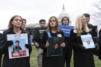 Kristin Bride, left, holding a photo of her 16-year-old son Carson, and Joann Bogard, holding a photo of her 15-year-old son Mason, center accompanied by other families, listen during a rally to protect kids online on Capitol Hill in Washington, Wednesday, Jan. 31, 2024. (AP Photo/Jose Luis Magana)