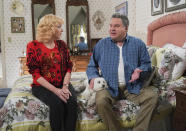 This image released by ABC shows Wendi McLendon-Covey as Beverly Goldberg, left and Jeff Garlin as Murray Goldberg in a scene from the comedy series "The Goldbergs." Costume designer Keri Smith creates the signature looks for the fictional Beverly. (Richard Cartwright/ABC via AP)