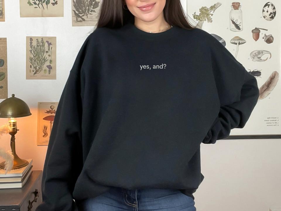 model wearing black yes and sweatshirt