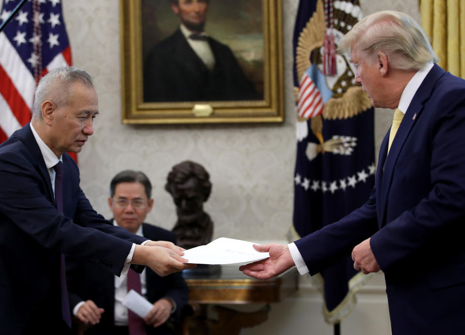 WASHINGTON, DC - OCTOBER 11:  Chinese Vice Premier Liu He presents U.S. President Donald Trump with a letter from Chinese President Xi Jinping after Trump announced a "phase one" trade agreement with China in the Oval Office at the White House October 11, 2019 in Washington, DC.  China and the United States have slapped each other with hundreds of billions of dollars in tariffs since the current trade war began between the world’s two largest national economies in 2018. (Photo by Win McNamee/Getty Images)
