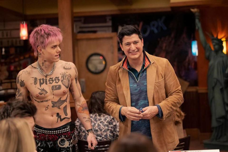 Case Walker and Ken Marino as Chase and Streeter standing in the middle of a fake Applebee's in Episode 7 of "The Other Two" 