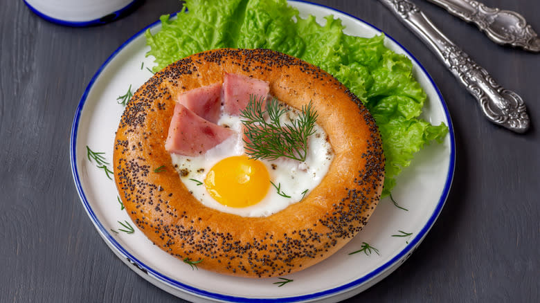 Egg, dill, and ham in middle of bagel