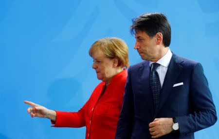 German Chancellor Angela Merkel and Italian Prime Minister Giuseppe Conte leave after a news conference at the chancellery in Berlin, Germany, June 18, 2018. REUTERS/Hannibal Hanschke