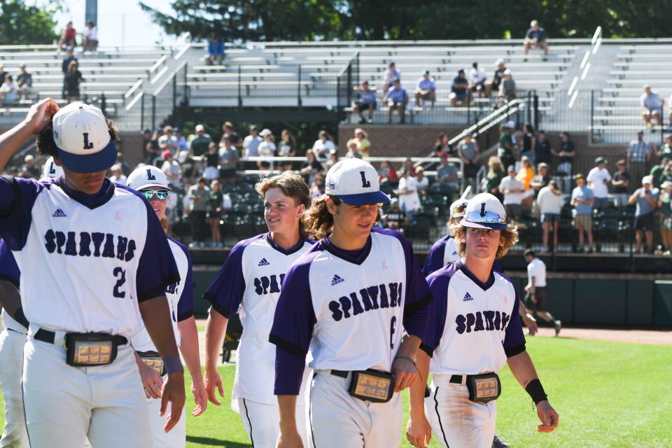 Members of the Lakeview baseball team leave the field Friday, June 17, 2022, following their 8-0 loss to Grosse Pointe North at the D1 MHSAA state semifinal at McLane Stadium in East Lansing.