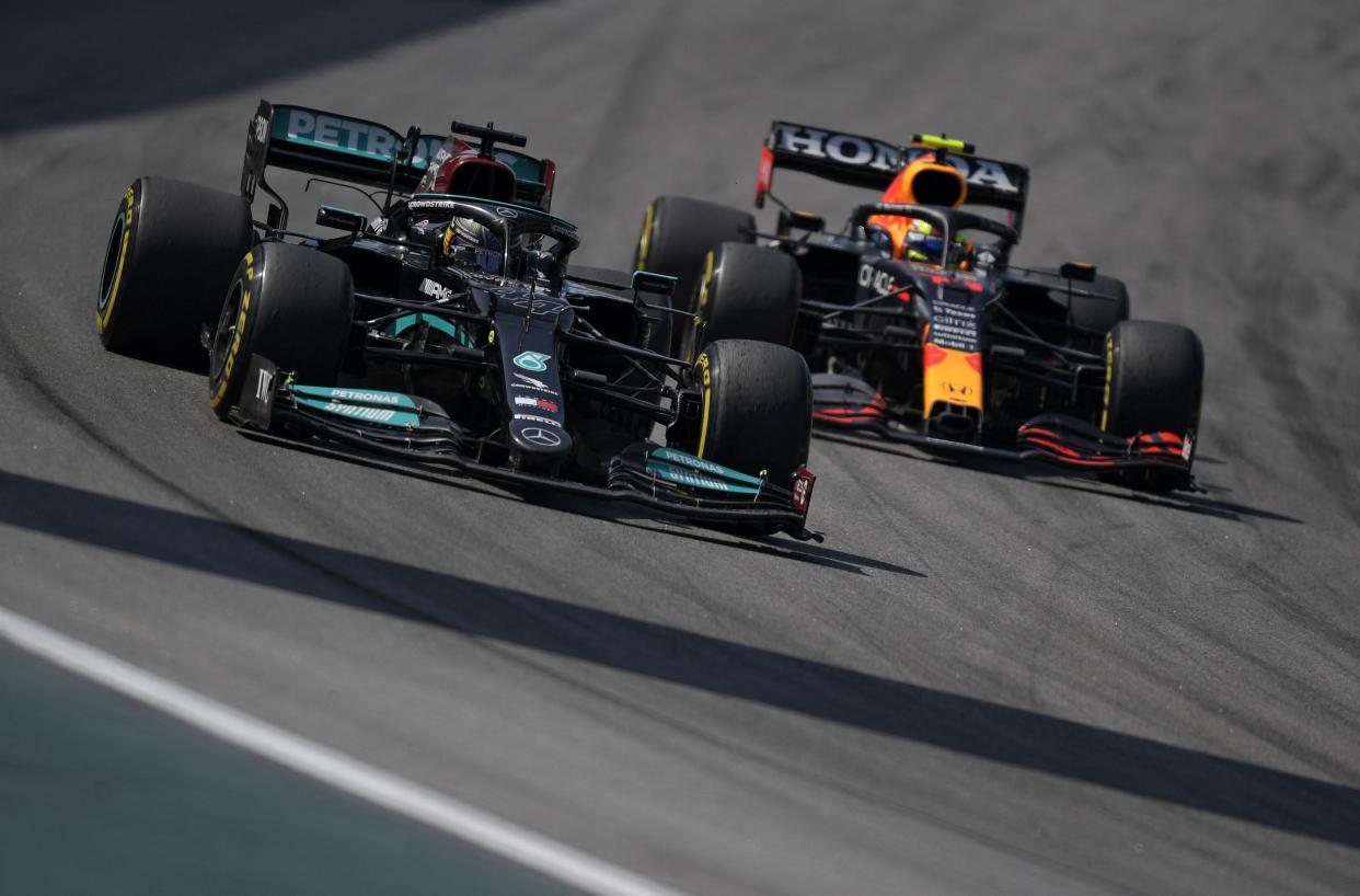 Lewis Hamilton passes Sergio Perez during Brazil's Formula One Sao Paulo Grand Prix.