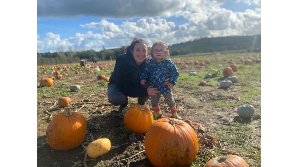 Willow in pumpkin patch with her her mum