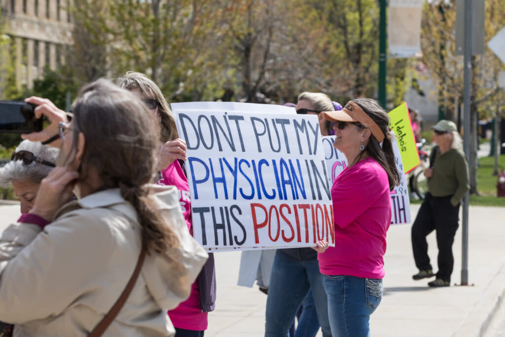 Supporters hold signs in support of their doctors and abortion access at a rally in Boise, Idaho