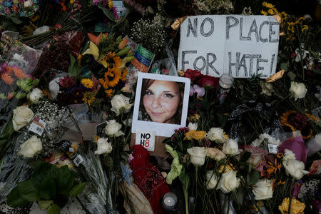 FILE PHOTO: A photograph of Charlottesville victim Heather Heyer is seen amongst flowers left at the scene of the car attack on a group of counter-protesters that took her life during the "Unite the Right" rally as people continue to react to the weekend violence in Charlottesville, Virginia, U.S. on August 14, 2017. REUTERS/Justin Ide/File Photo