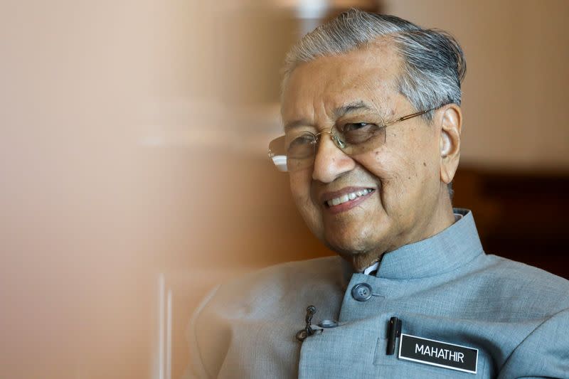 Malaysia's Prime Minister Mahathir Mohamad reacts during an interview with Reuters in Putrajaya