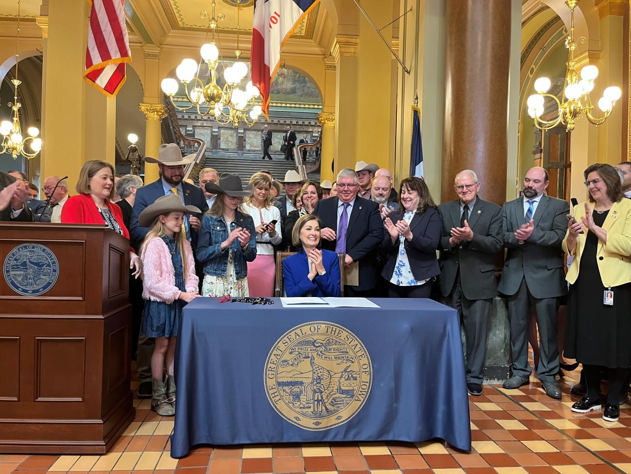 Gov. Kim Reynolds signs a law with new disclosure requirements for foreign owners of Iowa farmland, and increased penalties if they fail to comply, at the Iowa Capitol on Tuesday, April 9, 2024.