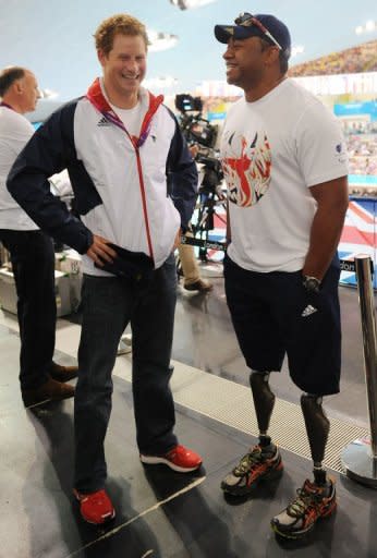 Britain's Prince Harry (L) talks with former British soldier and Paralympic athlete Derek Derenalagi at the Aquatics Centre during the London 2012 Paralympic Games at the Olympic Park in London