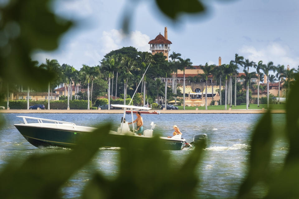 Boaters pass President Trump's Mar-a-Lago estate in Palm Beach, Fla.  (AP Photo/J. David Ake)