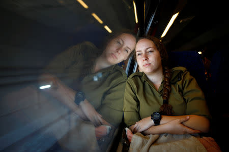 An Israeli soldier is reflected in the window as she travels on Israel's new high-speed rail line from Ben Gurion International Airport to Jerusalem September 25, 2018. REUTERS/Amir Cohen