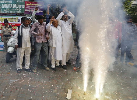 Supporters of Janata Dal (United) celebrate after learning the initial results outside the party office in New Delhi, India, November 8, 2015. REUTERS/Anindito Mukherjee