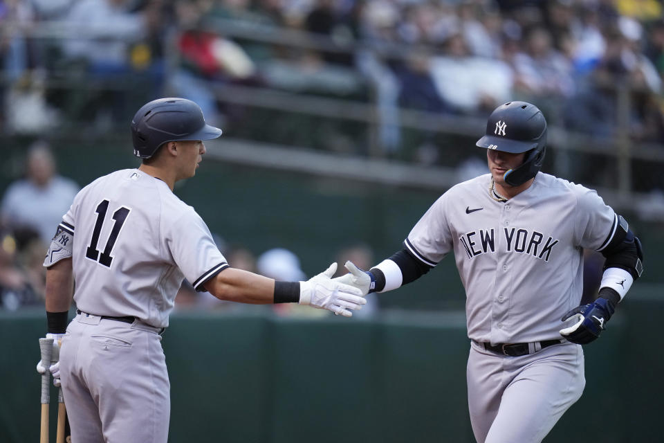 New York Yankees' Josh Donaldson, right, celebrates with Anthony Volpe after hitting a solo home run during the fifth inning of the team's baseball game against the Oakland Athletics in Oakland, Calif., Tuesday, June 27, 2023. (AP Photo/Godofredo A. Vásquez)