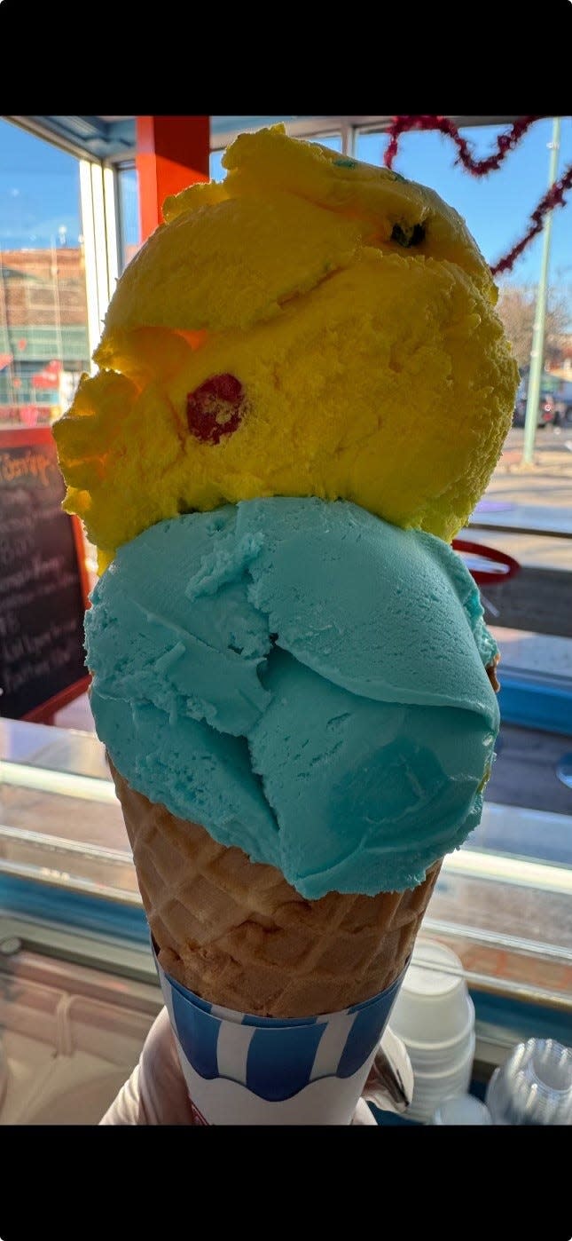 Two scoops of unique ice cream flavors, Play Dough and Blue Moon, sit atop a cone at 2 Scoopz Ice Cream in downtown Canton.