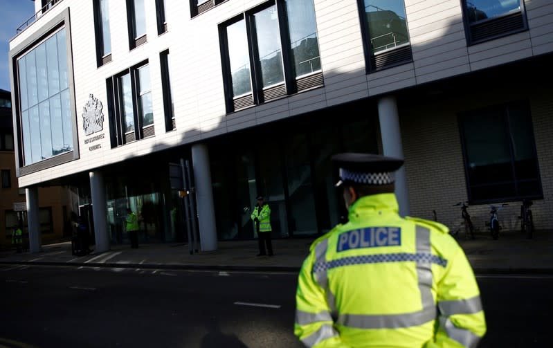 Police officers stand outside Chelmsford Magistrates' Court