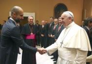 Pope Francis shakes hands with Bayern Munich's coach Pep Guardiola during a private audience of the Bayern Munich soccer team at the Palace of the Vatican, in Vatican City October 22, 2014. REUTERS/Alexander Hassenstein/Pool