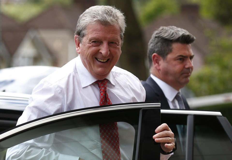 England's soccer manager Roy Hodgson, left, arrives to announce the national squad for the upcoming World Cup in Brazil, in Luton, England, Monday, May 12, 2014.(AP Photo/Sang Tan)