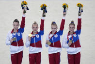 Russian Olympic Committee's artistic gymnastics women's team, from right, Liliia Akhaimova, Viktoriia Listunova, Angelina Melnikova and Vladislava Urazova celebrate after winning the gold medal at the 2020 Summer Olympics, Tuesday, July 27, 2021, in Tokyo.(AP Photo/Natacha Pisarenko)