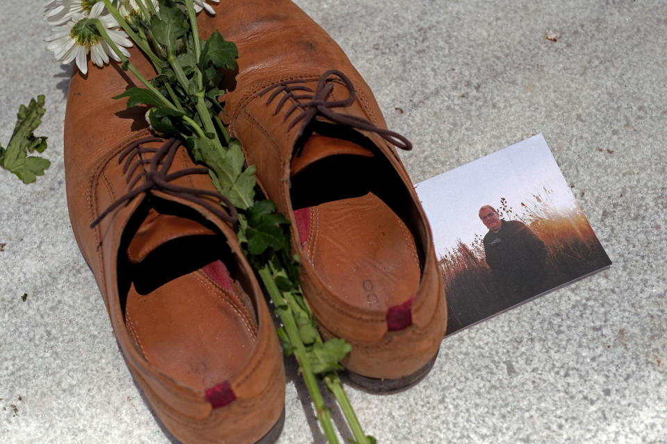 A photo of Luis Manuel Vazquez among the shoes at the Capitol in San Juan. (Photo: RICARDO ARDUENGO / Getty Images)