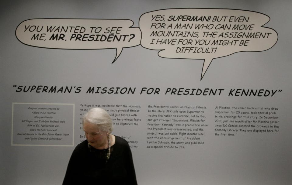 Ann Marie Plastino, widow of Al Plastino, the artist who drew the 1964 DC comic book "Superman's Mission for President Kennedy" stands in an exhibit, which opened today, at the John F. Kennedy Presidential Library and Museum in Boston, Thursday, March 20, 2014. Al Plastino died when he was 91 on Nov. 25, 2013. After the comic book's publication the original art went missing until 1993. It was finally donated to the library's permanent collection in December 2013 by comic book publisher DC Entertainment and will be on display through May 31, 2014. (AP Photo/Stephan Savoia)