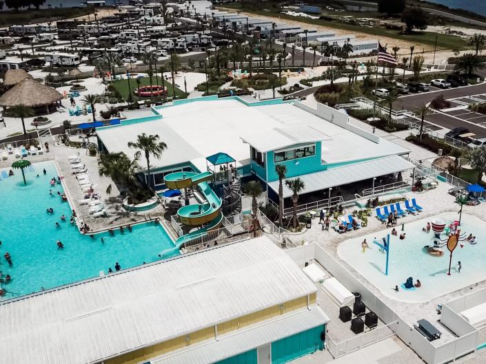 An overhead view of the pools at the camp. There&#39;s a waterslide sliding into one pool, and a shallower kids pool nearby.