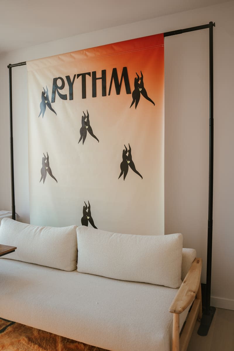 Rythm poster behind sofa in Brooklyn apartment.