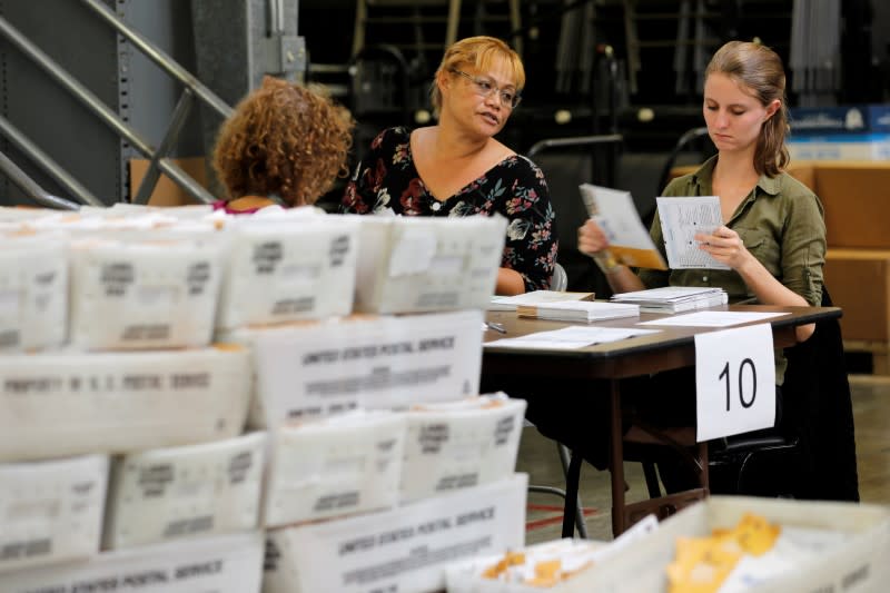 FILE PHOTO: Election workers deal with early mail-in ballots for the upcoming congressional elections in Orange County at the Registrar of Voters in Santa Ana, California