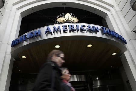 People walk past the British American Tobacco offices in London, Britain October 21, 2016. REUTERS/Stefan Wermuth