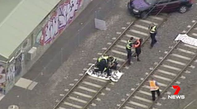 At least two Manus Island protesters have been arrested after a car was used to block rail lines heading to Flemington. Source: 7 News