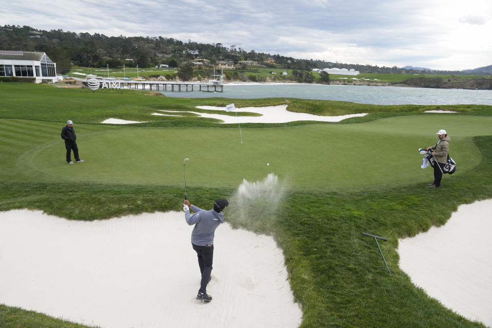 Sahith Theegala hits out of a bunker onto the 17th green of the Pebble Beach Golf Links during a practice round of the AT&T Pebble Beach National Pro-Am golf tournament in Pebble Beach, Calif., Wednesday, Jan. 31, 2024. (AP Photo/Eric Risberg)